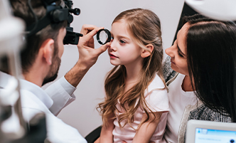 Doctor using eye machine on small child
